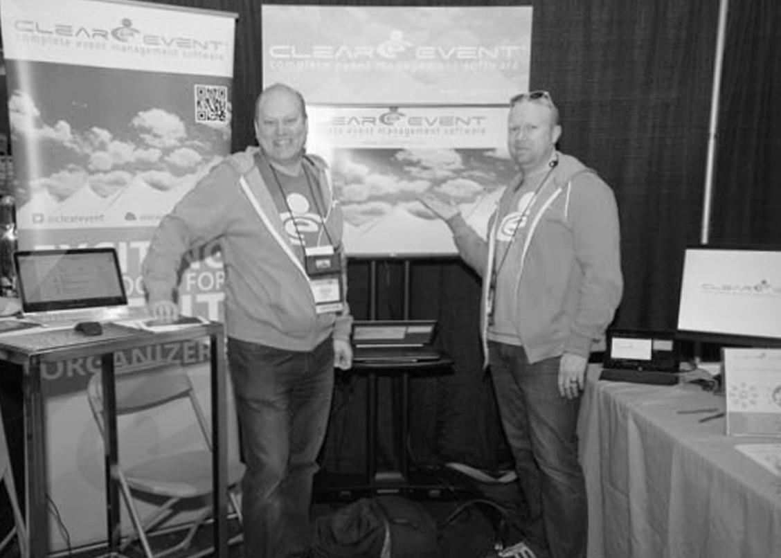 Picture showing 2 ClearEvent employees in a kiosk from the early days of ClearEvent in 2014 promoting the ClearEvent event management software at an exhibition.